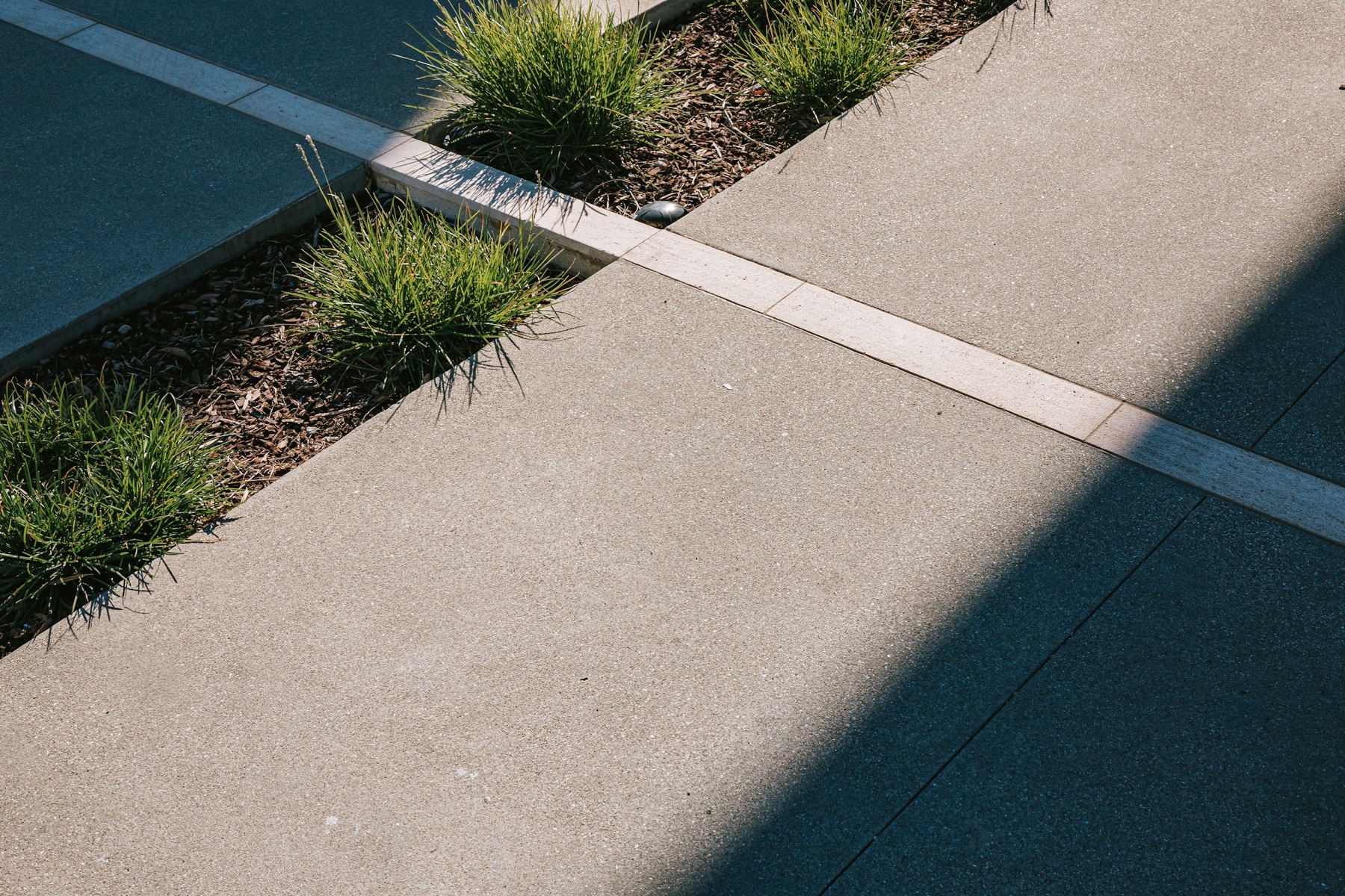 Broom-finished concrete walkway with a clean expansion joint